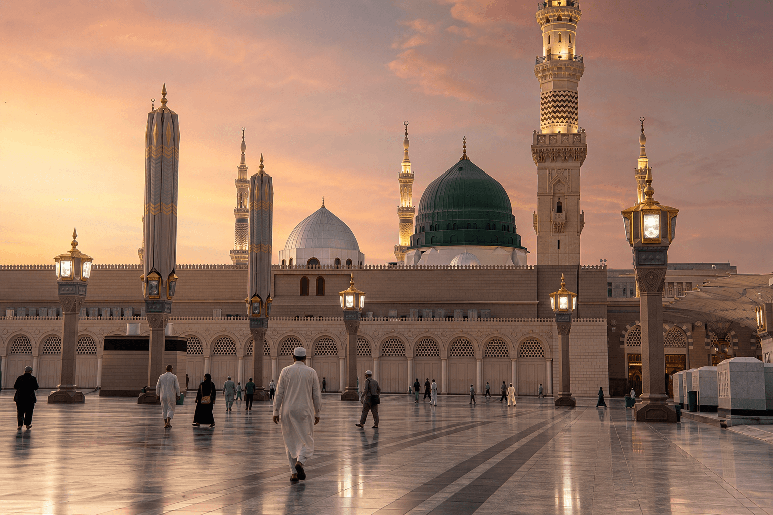 Pilgrims walking across the marble courtyard of the Prophet's Mosque in Madinah at dawn